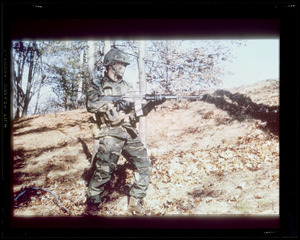 Soldier with gun in camouflage uniform