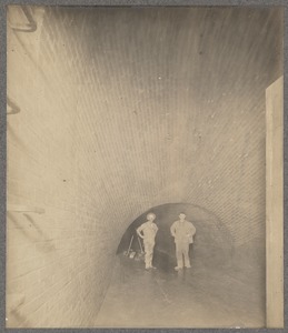 Men standing in sewer