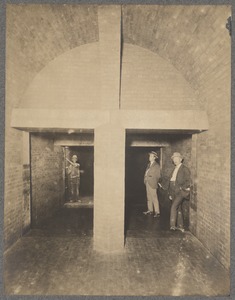 Men and worker standing in divided sewer