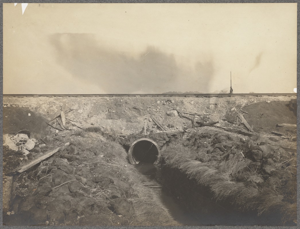 Water exiting culvert under railroad