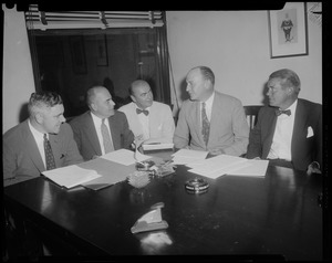 Five men seated at table