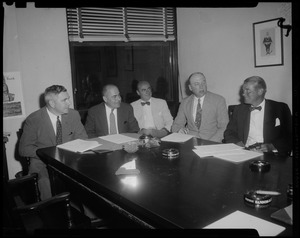 Five men seated at table