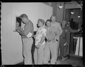 Line of men standing at the window