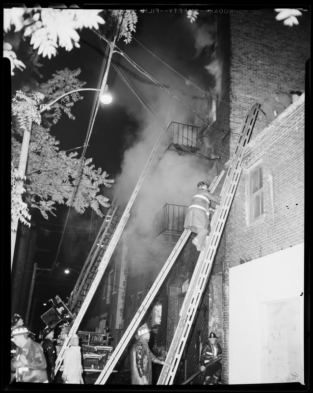 Firefighters and ladders on a smoking building - Digital Commonwealth