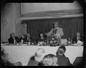 Man at podium addressing the room