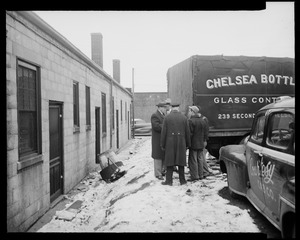 Group of five men standing near a Chelsea Bottle Glass Container truck and Courtesy Cab Co. vehicle
