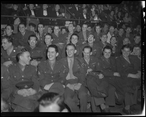 Seated crowd of military men laughing
