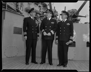 Three military men on deck of USS Albany