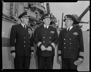 Three military men on deck of USS Albany