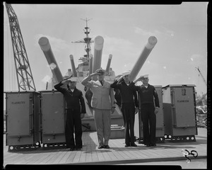 Cyrus B. Holcomb, Theodore Zelany, Robert W. Coleman, and John Ziemba, crew members of USS Albany, saluting on ship deck before its decommission
