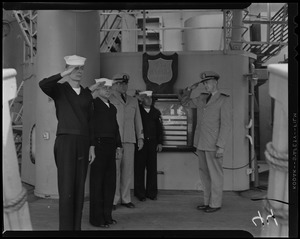 Cyrus B. Holcomb, Theodore Zelany, Robert W. Coleman, and John Ziemba, crew members of USS Albany, salute deck officer Ens. Thomas Tivnan on deck of U.S.S. Albany for final time before its decommissioning