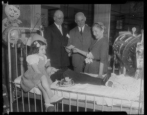 Helen Hayes at Mary McArthur Hospital, Wellesley, presenting check to Dr. P. D. Howe, Children's Hospital president, while Edward C. Donnelly, Jr., Bay State vicechairman of the March of Dimes, Nancy Locke, and Joseph Locke, polio patient, look on