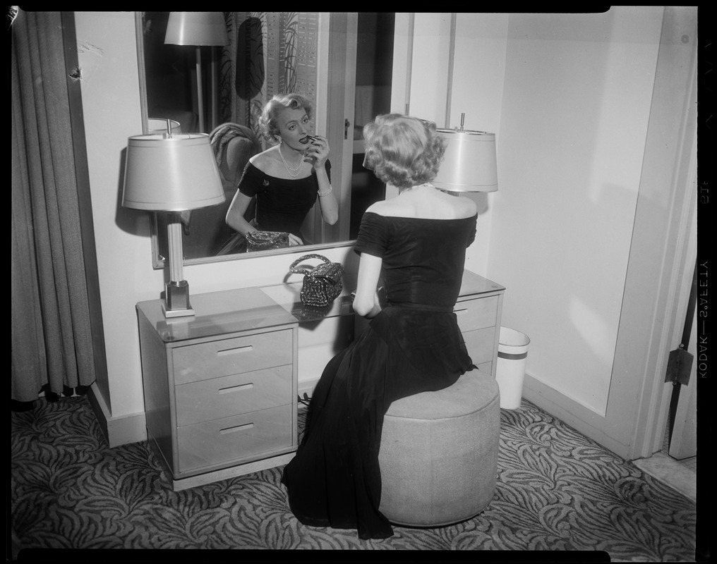 Christine Jorgenson putting on lipstick in the mirror - Digital ...