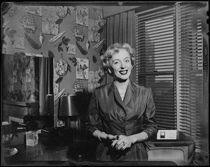 Christine Jorgenson posing for the camera, hands clasped in front