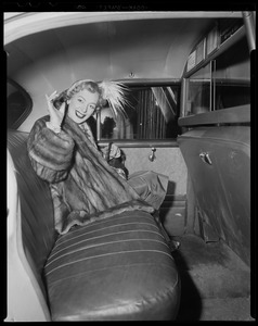 Christine Jorgenson in the back of a vehicle