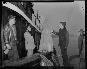 Jennifer Jones boarding a ship, with the help of a man