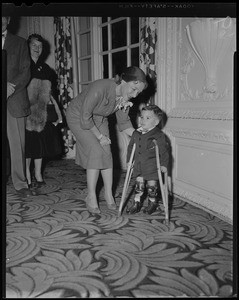 Helen Hayes leaning over to talk to James M[illegible] of Canton, the State Poster Boy for March of Dimes