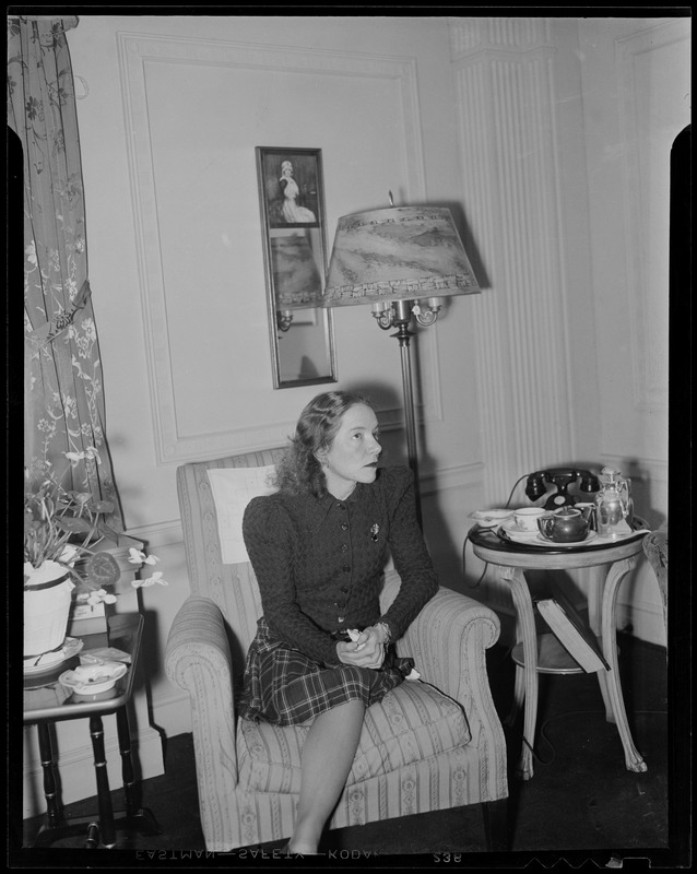 Helen Hayes sitting in a chair, looking upwards