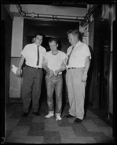Jail escapees nabbed. Later police captured Richard Powers in Roxbury. Detectives escort him into Boston Police headquarters for questioning