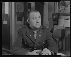 Walter Brown, sitting in military uniform at desk