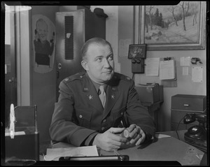 Walter Brown, sitting in military uniform at desk