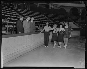 Four women skating as Walter Brown and two other men look on