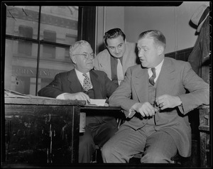 Walter Brown and two men sitting at a desk
