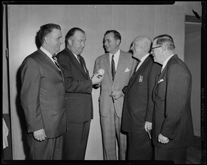 Walter Brown and another man holding autographed baseball while three other men look on