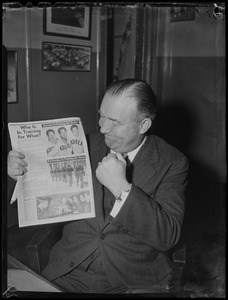 Walter Brown shaking his fist at the article about Koreans training for Boston Marathon and Bostonians training for Korean War