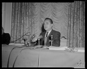 Governor George Wallace sitting behind microphones