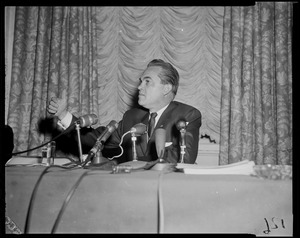 Governor George Wallace gesturing behind microphones