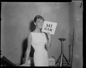 Anna Maria Alberghetti posing with a Sat. 11 a.m. sign