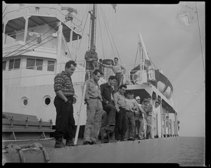 Group of 14 men stand on deck of Liberian freighter Alberta, anchored off Cape Cod canal, after Captain Gerasimos Potamianos was overpowered by the crew following his murder attempt on Elefehrios Metaxes