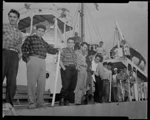 Group of 15 men stand on deck of Liberian freighter Alberta, anchored off Cape Cod canal, after Captain Gerasimos Potamianos was overpowered by the crew following his murder attempt on Elefehrios Metaxes