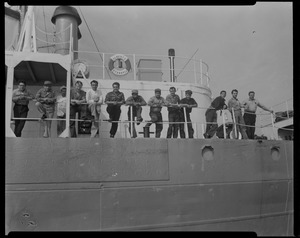 Group of 13 posing on deck of Liberian freighter Alberta, anchored off Cape Cod canal, after Captain Gerasimos Potamianos was overpowered by the crew following his murder attempt on Elefehrios Metaxes