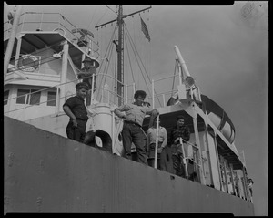 Close-up of group on on deck of Liberian freighter Alberta, anchored off Cape Cod canal, after Captain Gerasimos Potamianos was overpowered by the crew following his murder attempt on Elefehrios Metaxes