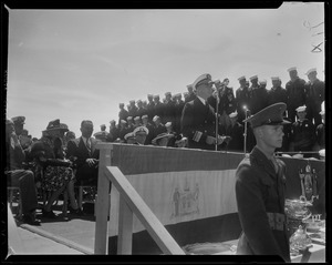 Military officer addressing the crowd during ceremony on USS Albany