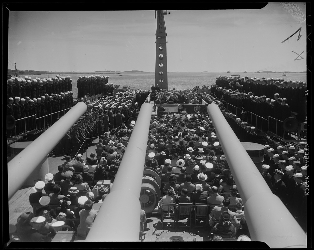 Shot of the ceremony from behind the crowd, featuring the cannons