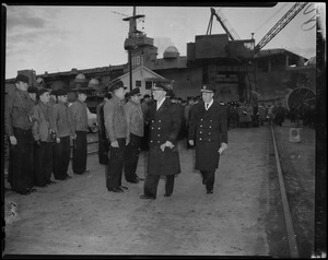 Ship officers walking by the crew ranks