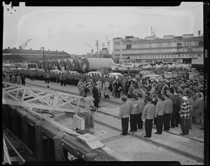 Crew lined up on dock by gangway with press