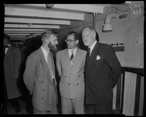 Three men talking on board the ship