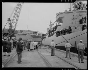 View of the U.S.S. ATKA at the dock with people standing on the dock