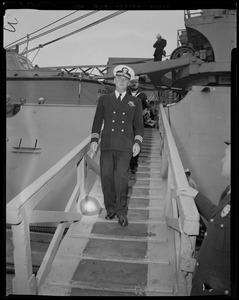 Man stepping down from the U.S.S. Atka on stairs