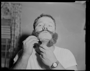 View of a crew member shaving his beard