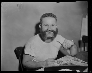 Portrait of a crew member sitting at a table with scissors