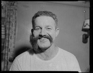 Portrait of a crew member with half of his beard shaved off