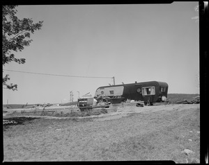 View of a mobile home and debris