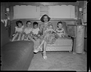 Woman and five children sitting on a couch