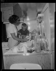 Woman and a child beside a sink
