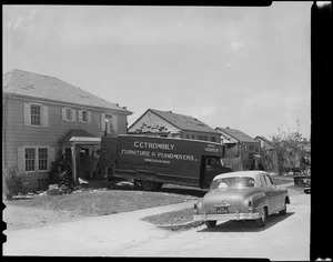 House with C.C. Trombly Furniture & Piano Moves truck in driveway